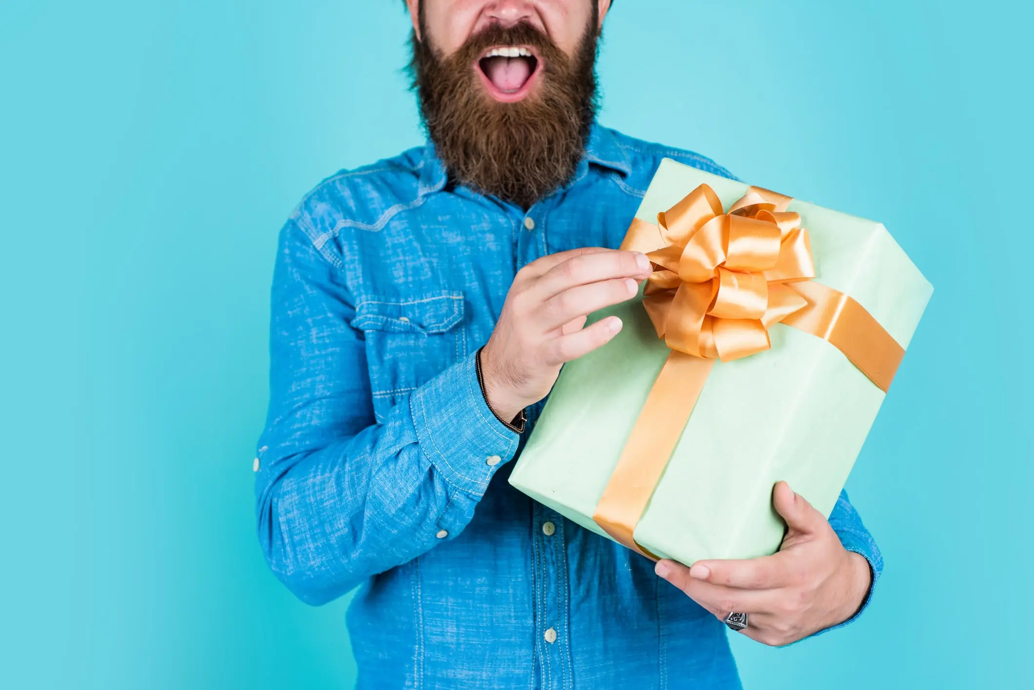 gifts-for-lineman man with beard holding gift